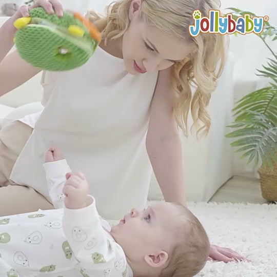 baby playing with avocado soft toy